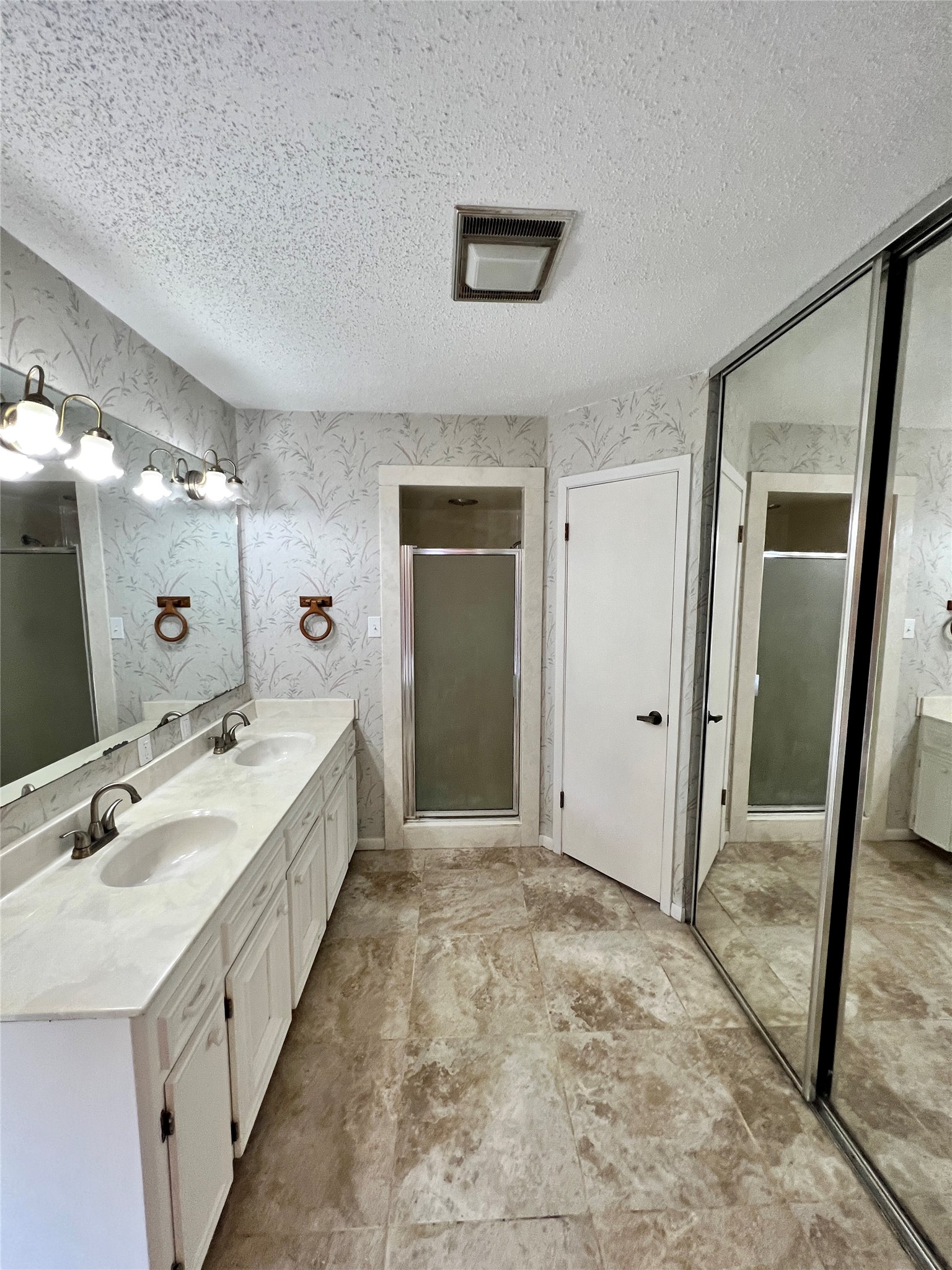 1602 Yokley Road Rockdale, TX 76567 - Photo 34 of 40 a spacious bathroom with a double vanity sink a mirror and a shower