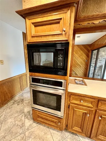 a stove top oven sitting inside of a kitchen