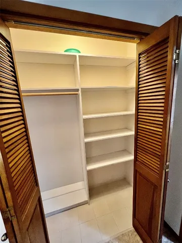a view of a livingroom with a ceiling fan and window