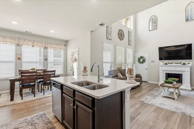 a living room with fireplace furniture and a flat screen tv