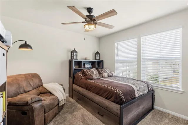 a bedroom with a bed couch and window