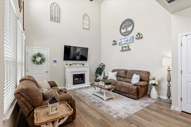 a living room with furniture a fireplace and a flat screen tv