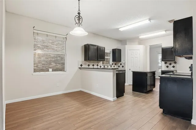 a kitchen with stainless steel appliances a refrigerator sink and microwave