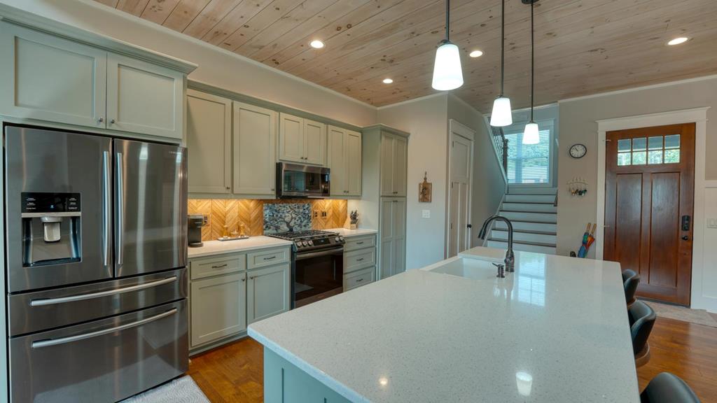 31 Elf School Road Hayesville, NC 28904 - Photo 27 of 59 a kitchen with kitchen island a sink stainless steel appliances and cabinets