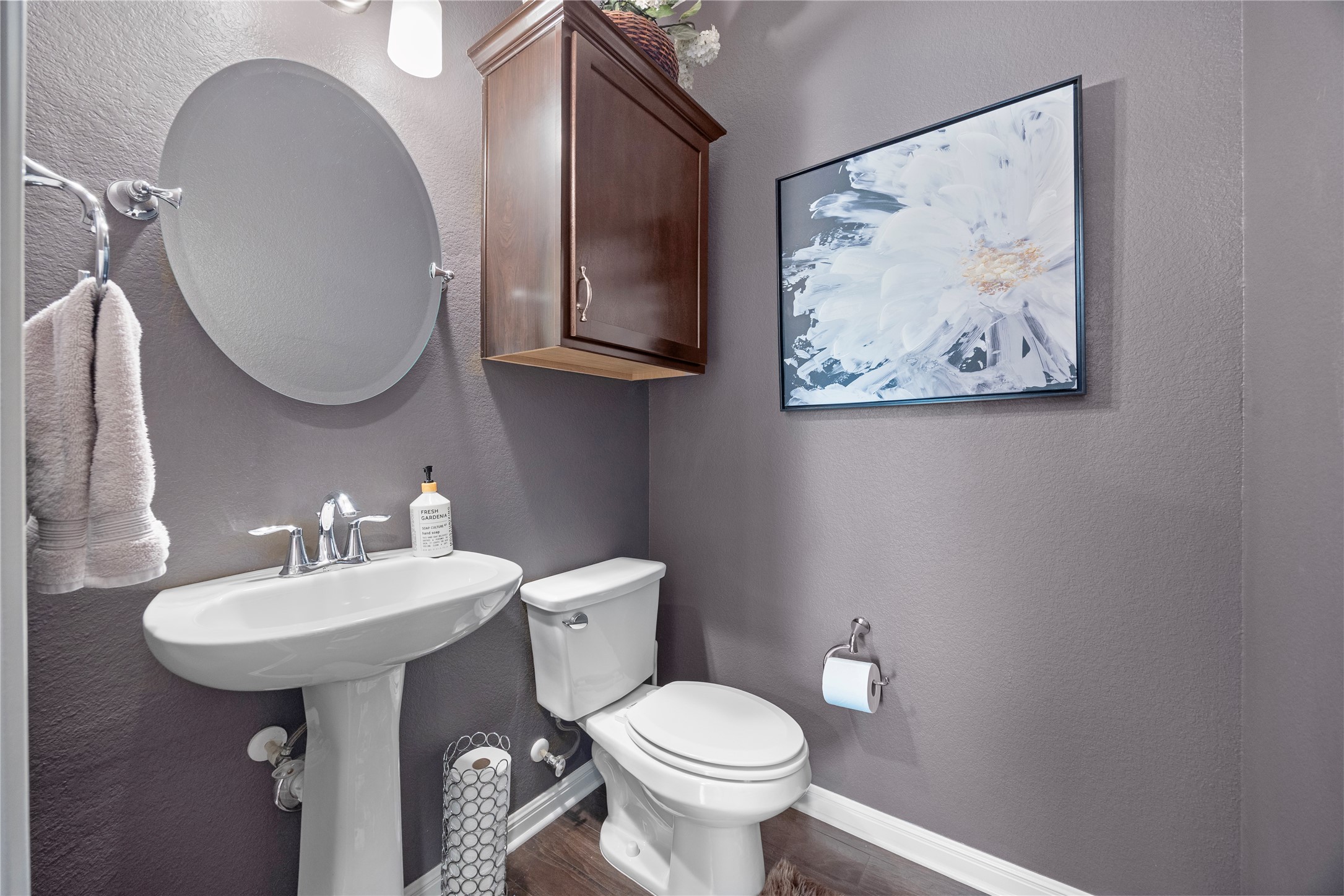 7308 Bandera Ranch Trail, Unit A Austin, TX 78750 - Photo 16 of 27 The bathroom features a pedestal sink with a chrome faucet, a wall-mounted mirror, and a toilet