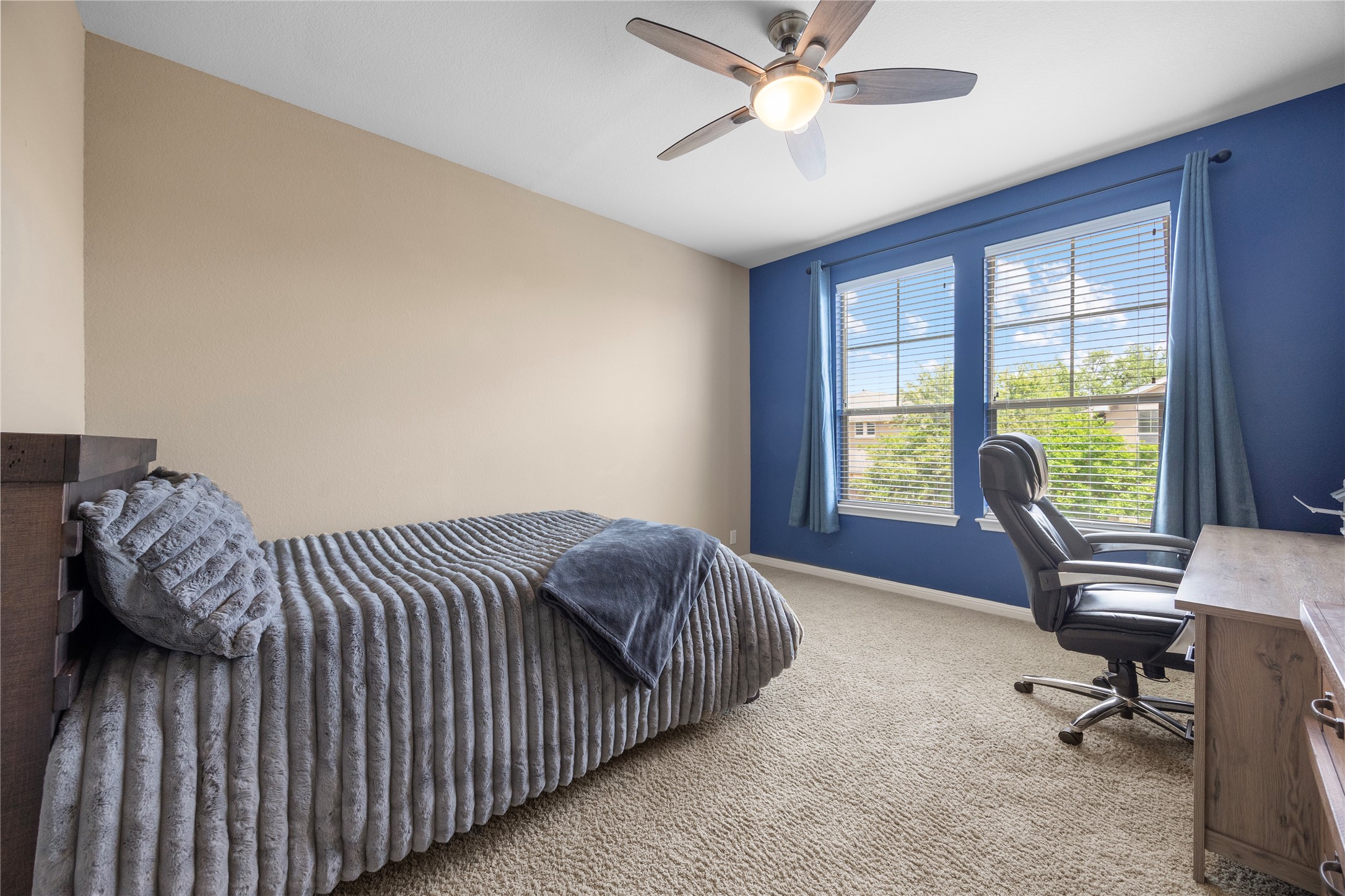 7308 Bandera Ranch Trail, Unit A Austin, TX 78750 - Photo 19 of 27 This room features a ceiling fan with integrated lighting, two windows providing natural light, and carpeted flooring