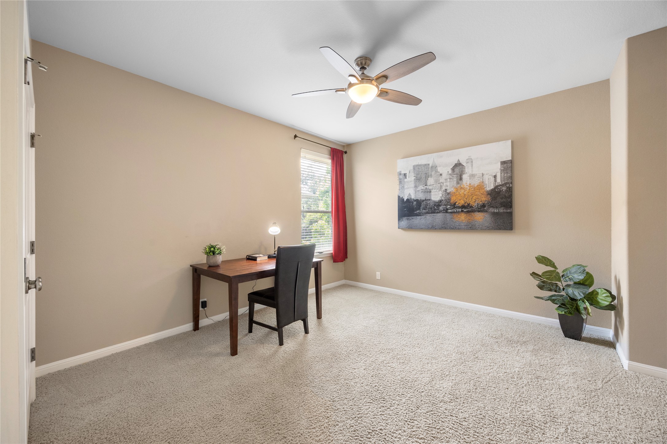 7308 Bandera Ranch Trail, Unit A Austin, TX 78750 - Photo 22 of 27 This room features neutral-toned walls, light carpeted flooring, and a ceiling fan with integrated lighting
