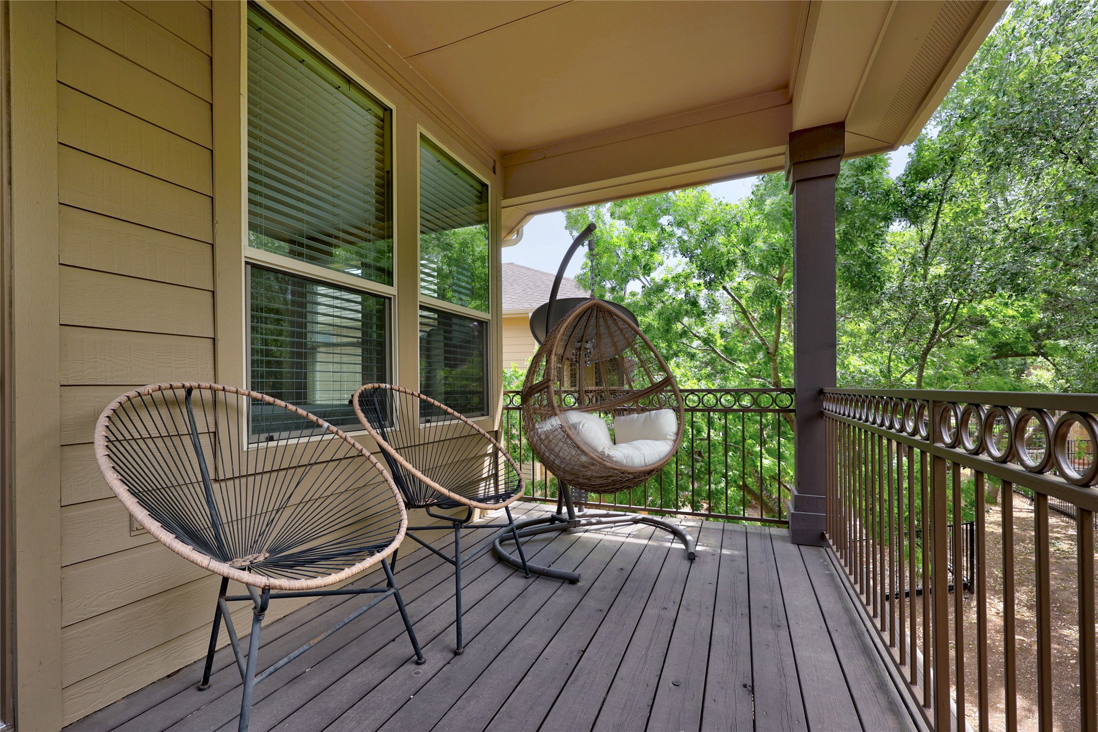 7308 Bandera Ranch Trail, Unit A Austin, TX 78750 - Photo 24 of 27 This inviting balcony features a wood plank floor and a decorative metal railing, offering treetop views