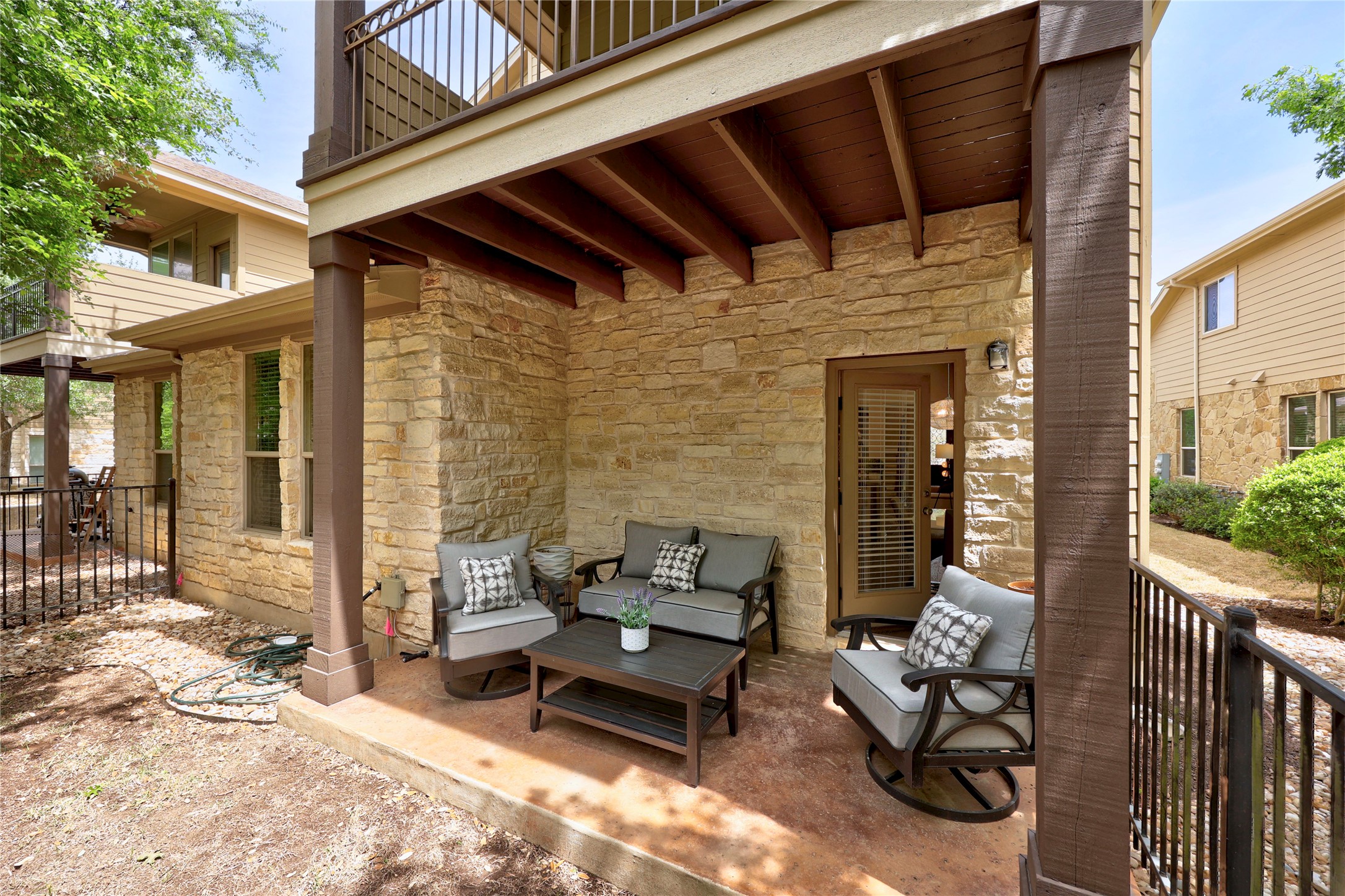 7308 Bandera Ranch Trail, Unit A Austin, TX 78750 - Photo 25 of 27 This property features a covered patio with a stone exterior, providing a private outdoor living space