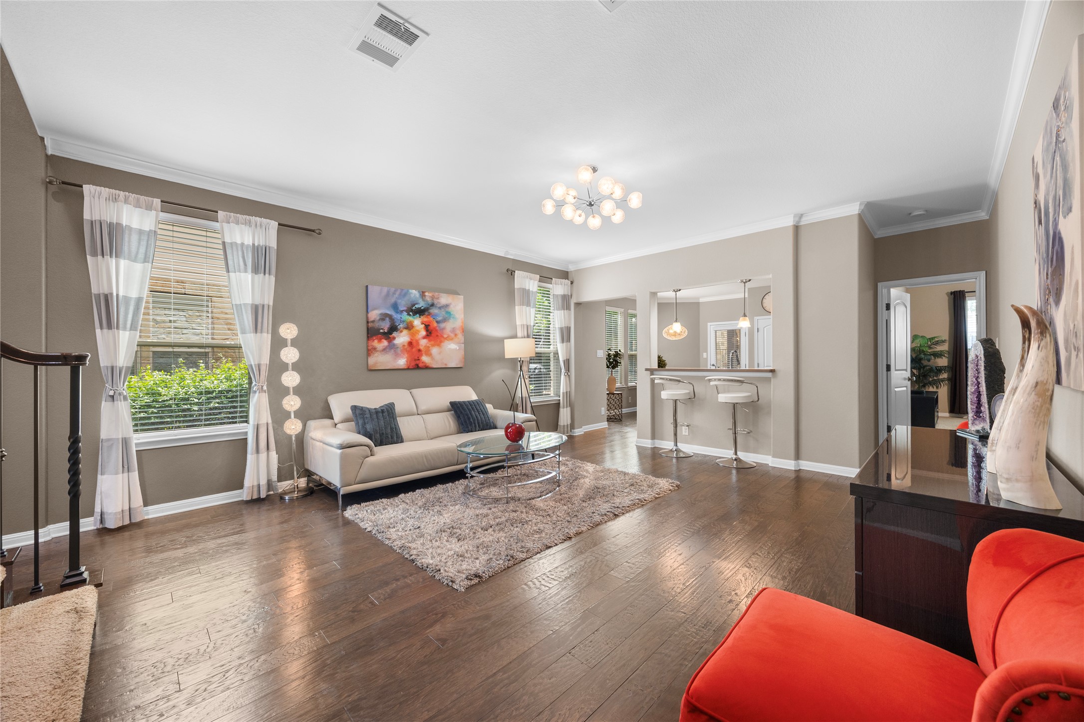 7308 Bandera Ranch Trail, Unit A Austin, TX 78750 - Photo 4 of 27 The living area features hardwood floors, light neutral wall colors, and crown molding