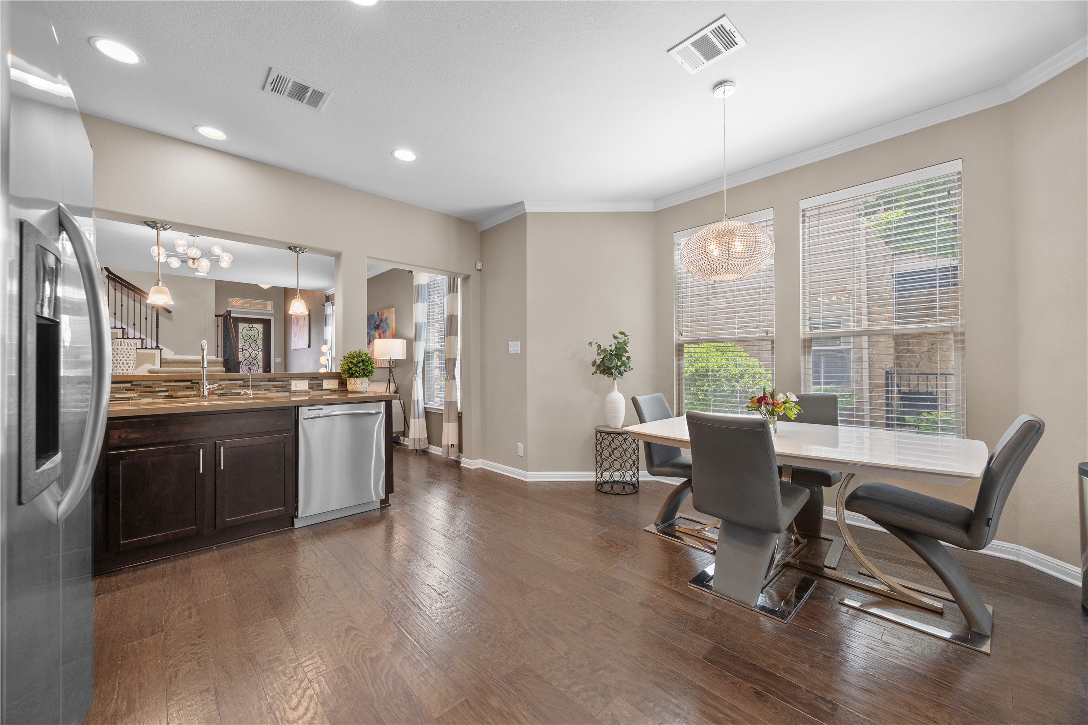 7308 Bandera Ranch Trail, Unit A Austin, TX 78750 - Photo 10 of 27 This bright dining area features large windows with blinds, a modern pendant light fixture, and hardwood floors