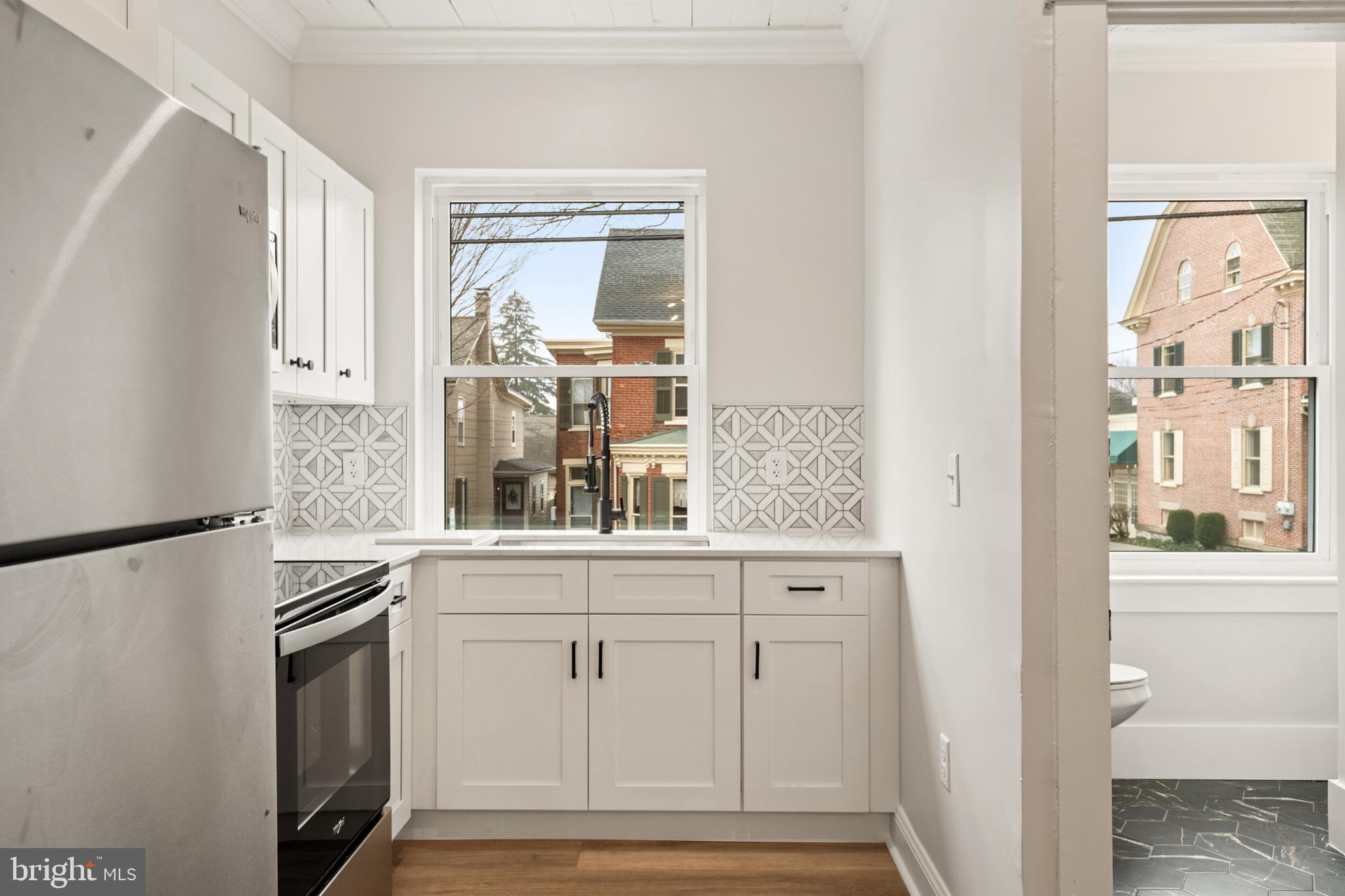 10-14 South Decatur Street, Unit 12C Strasburg, PA 17579 - Photo 7 of 12 a kitchen with granite countertop white cabinets and stainless steel appliances