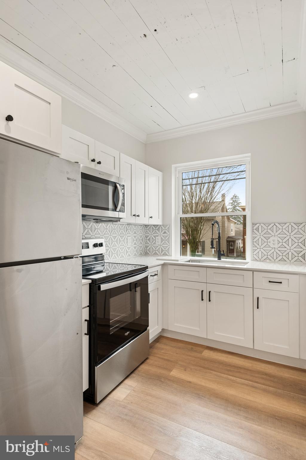 10-14 South Decatur Street, Unit 12C Strasburg, PA 17579 - Photo 8 of 12 a kitchen with granite countertop white cabinets and stainless steel appliances
