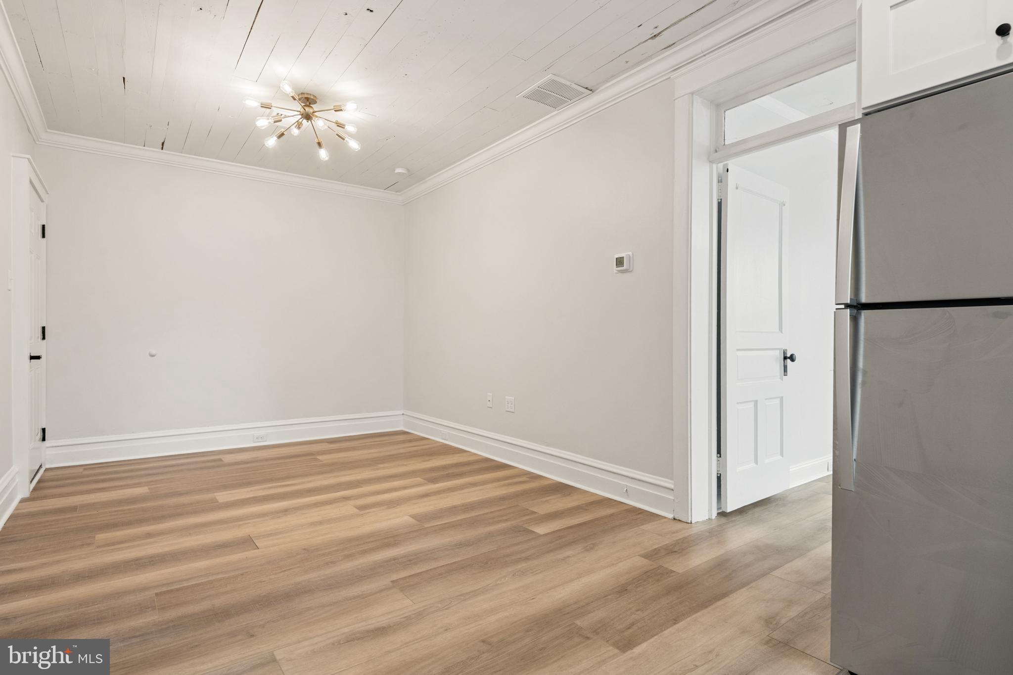 10-14 South Decatur Street, Unit 12C Strasburg, PA 17579 - Photo 9 of 12 a view of an empty room with a chandelier