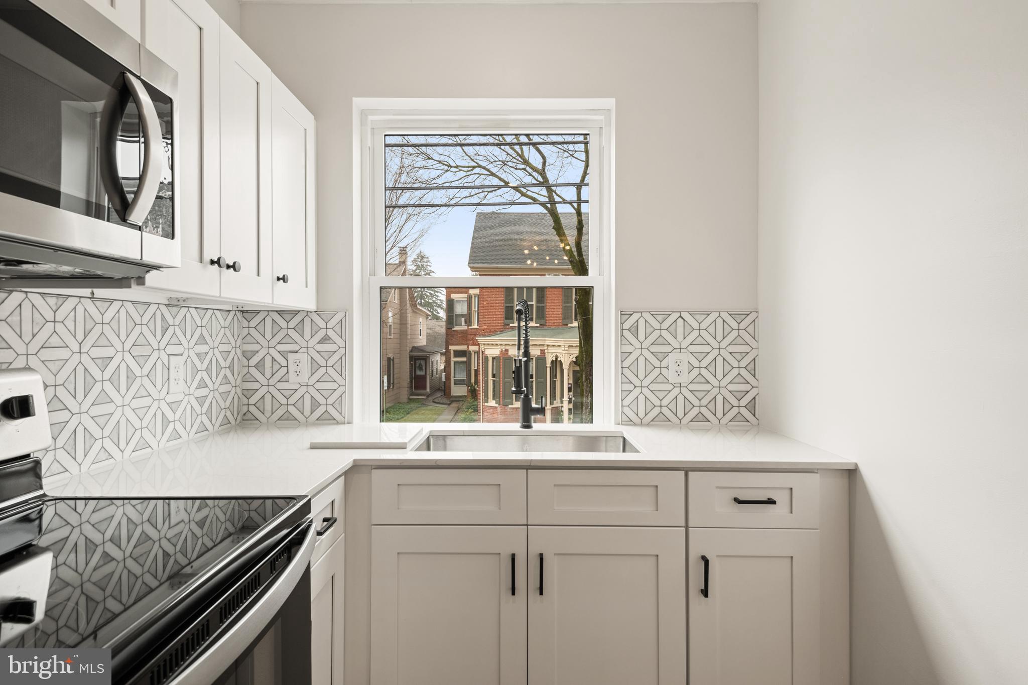 10-14 South Decatur Street, Unit 12C Strasburg, PA 17579 - Photo 10 of 12 a kitchen with a stove and a white cabinet