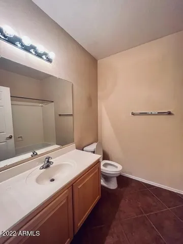 a bathroom with a double vanity sink toilet and a mirror