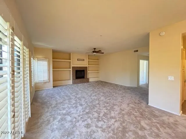 a view of empty room with a fireplace and cabinet