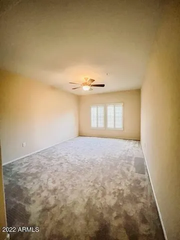 en empty room with windows and cabinet