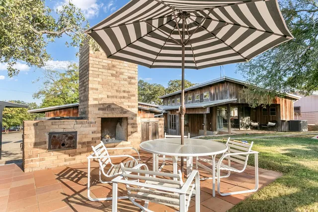 a outdoor space with lots of white furniture a rug and white walls