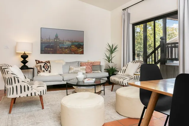 a large bed sitting in a bedroom next to a window