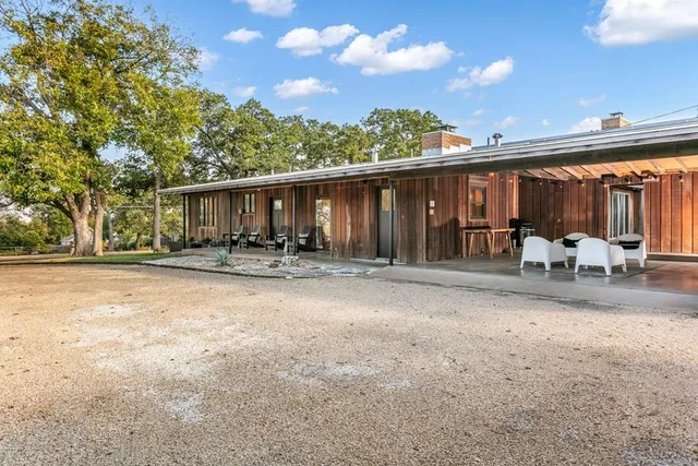 a living room with fireplace furniture and a rug