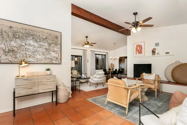 a living room with furniture a window and a fireplace