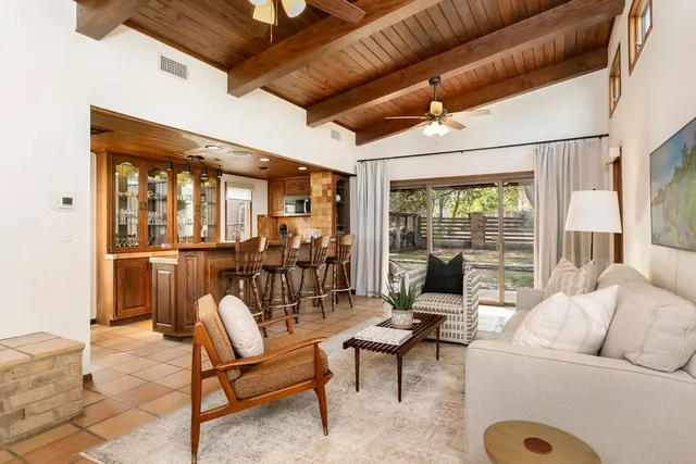 a view of a dining room with furniture large windows and wooden floor