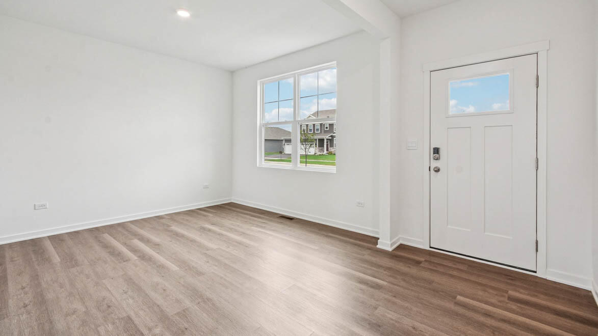 7694 West 107th Place Crown Point, IN 46307 - Photo 13 of 37 an empty room with wooden floor and windows