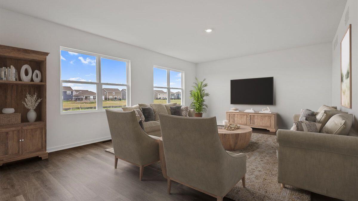 7694 West 107th Place Crown Point, IN 46307 - Photo 2 of 37 a living room with furniture and a flat screen tv