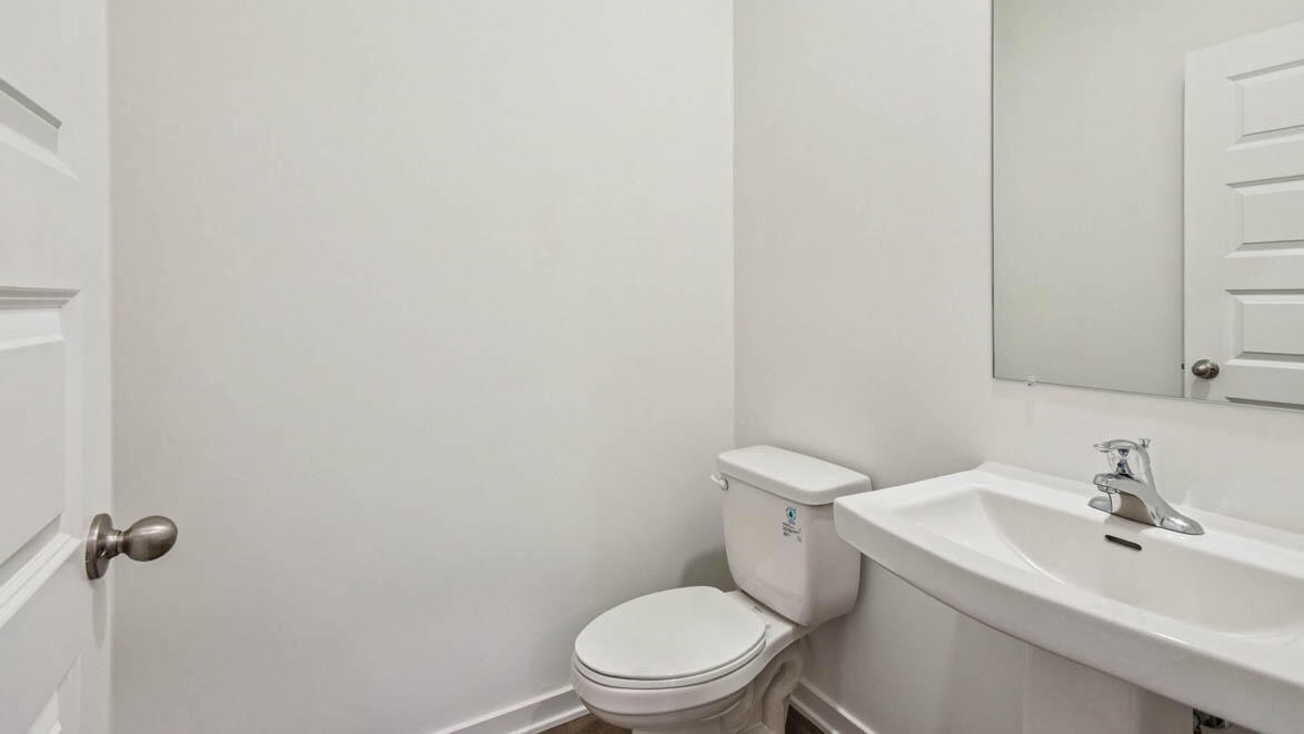 7694 West 107th Place Crown Point, IN 46307 - Photo 21 of 37 a white toilet sitting next to a bathroom sink
