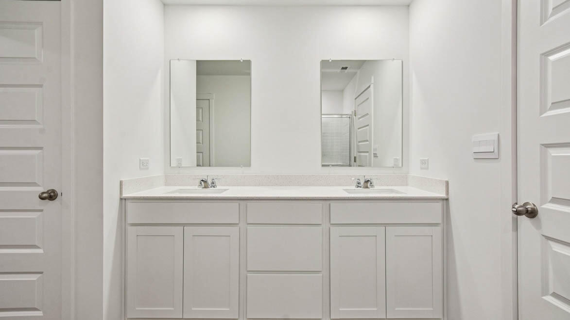 7694 West 107th Place Crown Point, IN 46307 - Photo 28 of 37 a bathroom with double sink and a mirror