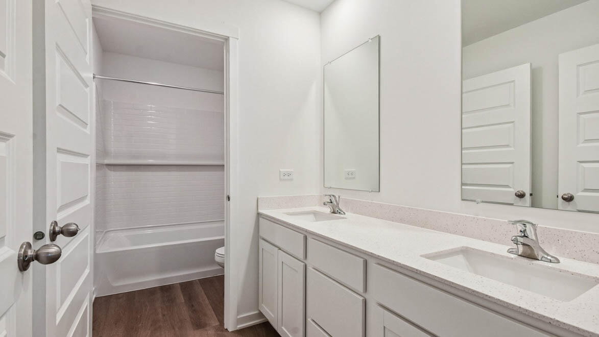 7694 West 107th Place Crown Point, IN 46307 - Photo 35 of 37 a bathroom with a sink and a mirror with bathtub