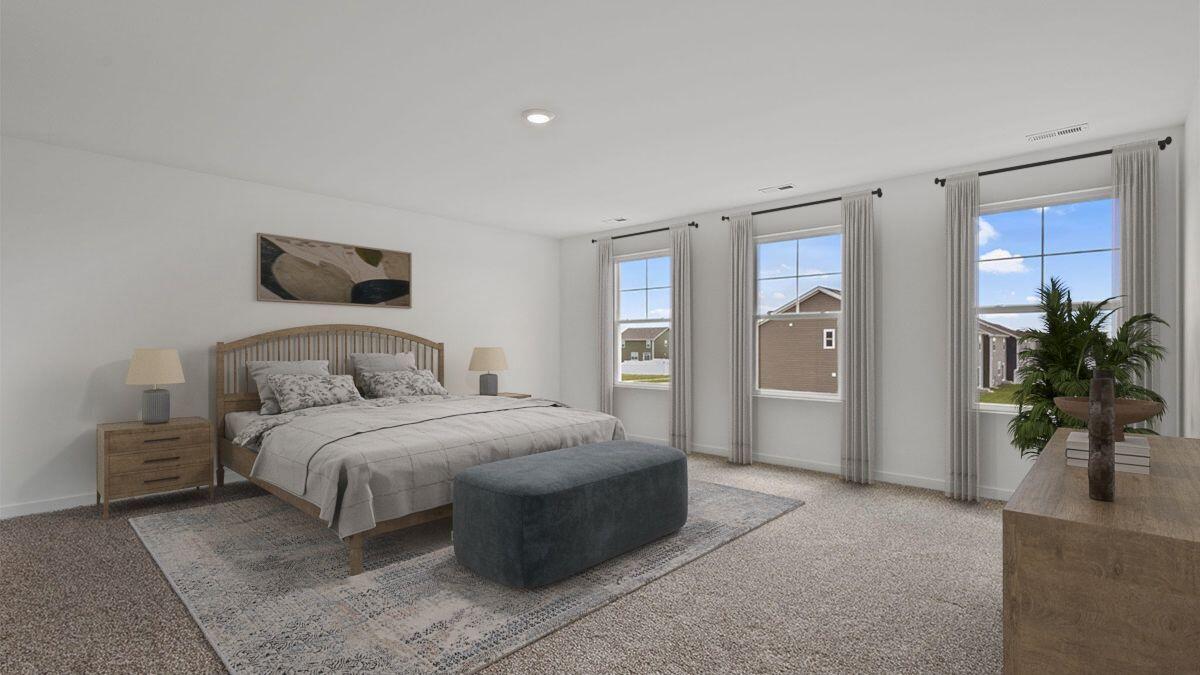 7694 West 107th Place Crown Point, IN 46307 - Photo 6 of 37 a spacious bedroom with a bed a couch and potted plant