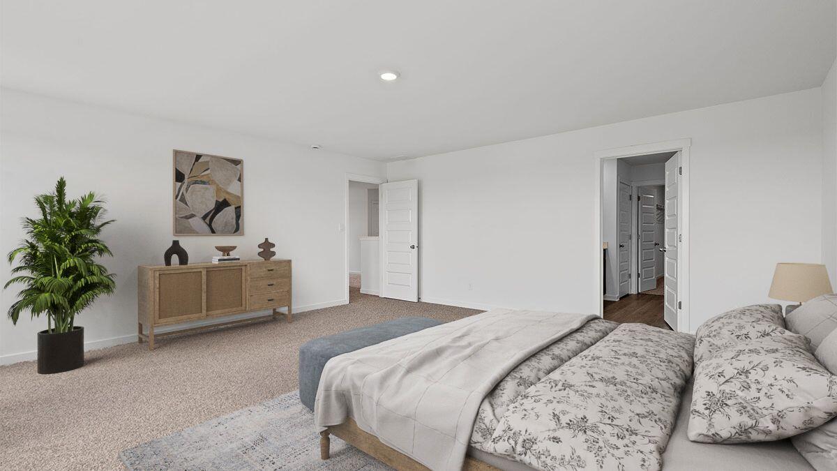 7694 West 107th Place Crown Point, IN 46307 - Photo 7 of 37 a bedroom with a bed and a potted plant