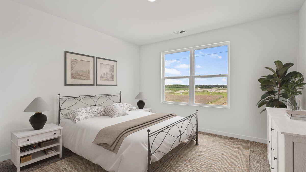 7694 West 107th Place Crown Point, IN 46307 - Photo 10 of 37 a bedroom with a bed and a window