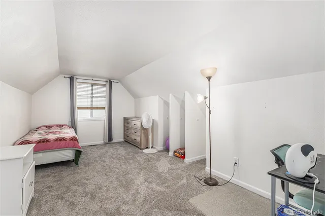 a bedroom with furniture and a window