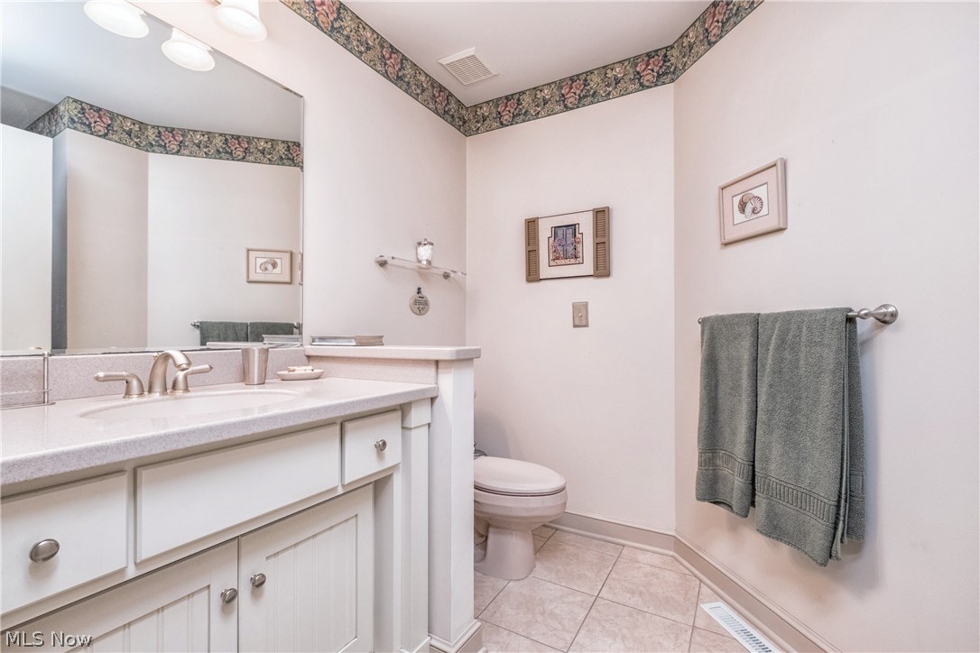 2815 Westdale Road Northwest Canton, OH 44708 - Photo 16 of 33 First floor bathroom with tile floors, step=in shower and solid surface vanity.