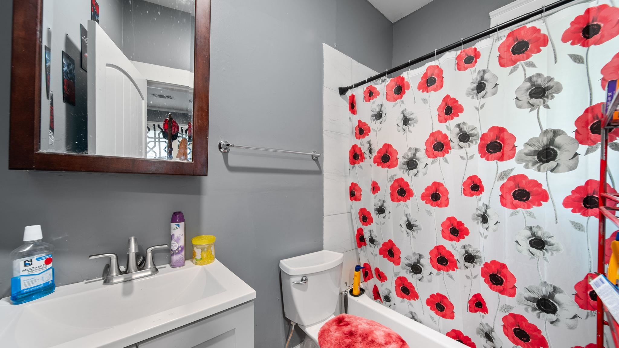 659 Decatur Street Memphis, TN 38107 - Photo 16 of 24 Bathroom featuring a white bathtub, toilet, and vanity with an integrated sink