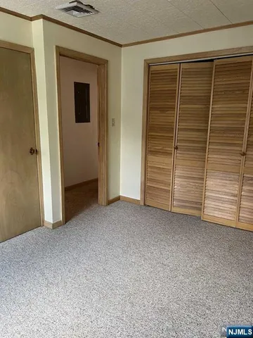 a view of an empty room and a window