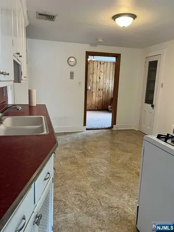 a kitchen with granite countertop a sink and a stove top oven