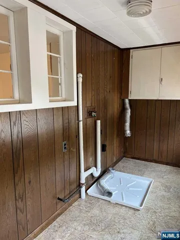 a view of an empty room with wooden walls