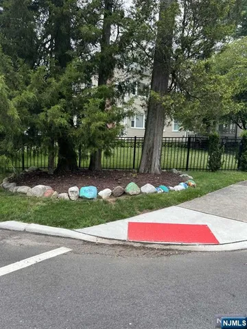 a view of a house with a yard and potted plants