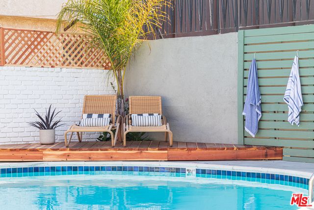 a view of staircase with white walls and a rug