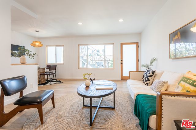 a living room with furniture a window and a table