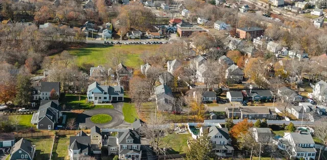 an aerial view of a house with a swimming pool outdoor seating and yard