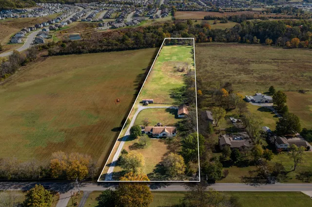an aerial view of house with yard