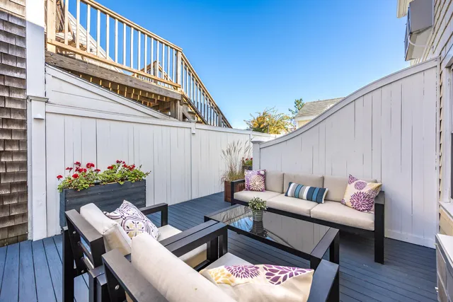 a bedroom with a bed a mirror and a large window
