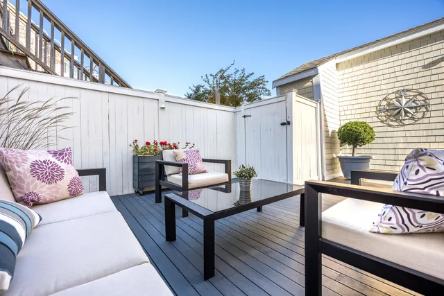 a view of a chairs and table in the balcony