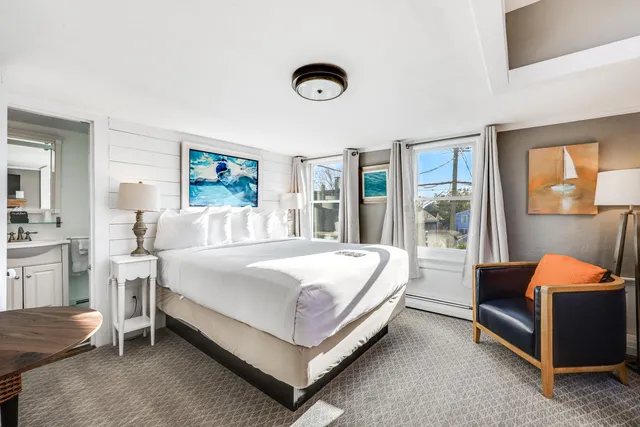 a bedroom with a large bed and a couch