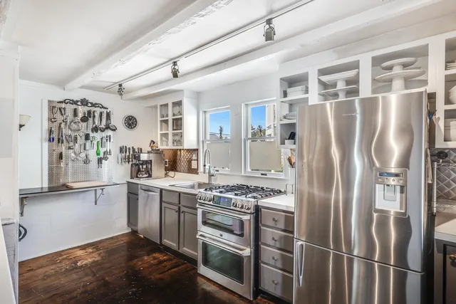 a kitchen with stainless steel appliances granite countertop a refrigerator and a stove